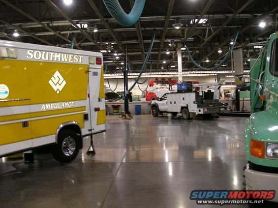 Yellow and white ambulance side view, with 'SOUTHWEST AMBULANCE' text