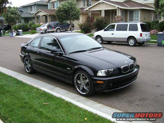 Black 2002 BMW 3 Series coupe parked on street