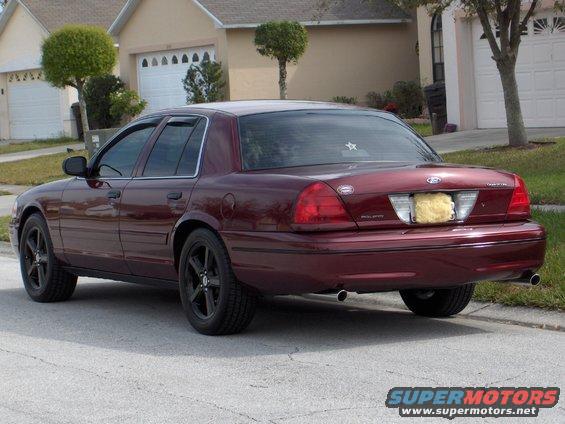 Maroon 2004 Ford Crown Victoria parked on street, rear 3/4 view