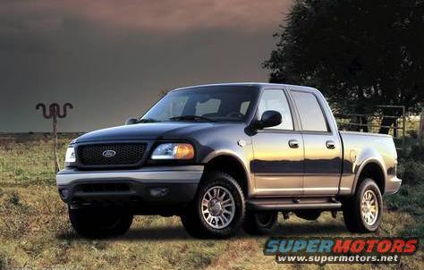 Gray Ford F-150 pickup truck, 1999 model year, parked outdoors with a dark sky