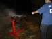 1979 Ford Bronco - A person cleans an engine block outdoors at night with a pressure washer.