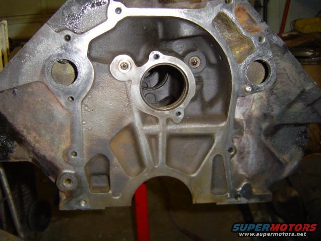 Engine block with oil residue and mounting holes, viewed from the front
