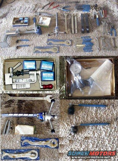 Collection of various metal tools including wrenches, calipers, and a dial indicator