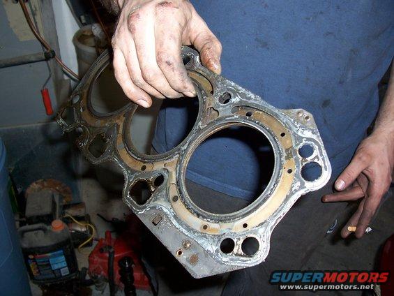 used engine head gasket held by a person
