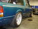 1997 Ford Ranger - A teal 1997 Ford Ranger pickup truck is shown from the rear quarter angle in a garage setting.