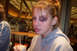 1989 Ford Bronco - A young woman with a black eye is seen in a public place, holding a beverage.
