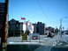 1997 Ford Escort - A street scene a motel, gas prices, and car wash advertisement under a clear blue sky.