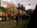 1997 Ford Escort - A street scene shows construction equipment and a pedestrian crossing the road in front of buildings.