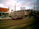 1997 Ford Escort - A maroon sedan is parked on a street with tram tracks and buildings in the background.