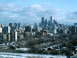 1997 Ford Escort - A wide view of the Toronto skyline under a cloudy sky, with snow covering the ground and trees.