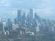 1997 Ford Escort - A wide view of a city skyline with numerous skyscrapers and buildings under a cloudy sky.