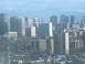 1997 Ford Escort - A wide view of a city skyline, many buildings of varying heights under a cloudy sky.
