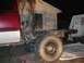 2001 Dodge 1500 - The rear chassis and large tires of a truck are visible, with a portion of the cab in red and silver. The vehicle appears to be incomplete…