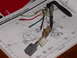 1995 Ford Bronco - A wiring harness is placed over a vehicle component location diagram, with visible labels and text.