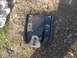 2001 Dodge 1500 - A black metal part with bolt holes and a circular opening is visible on the ground.