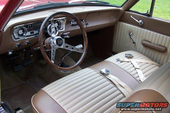 1965 Ford Falcon interior with tan seats, wood-rimmed steering wheel, and dashboard gauges