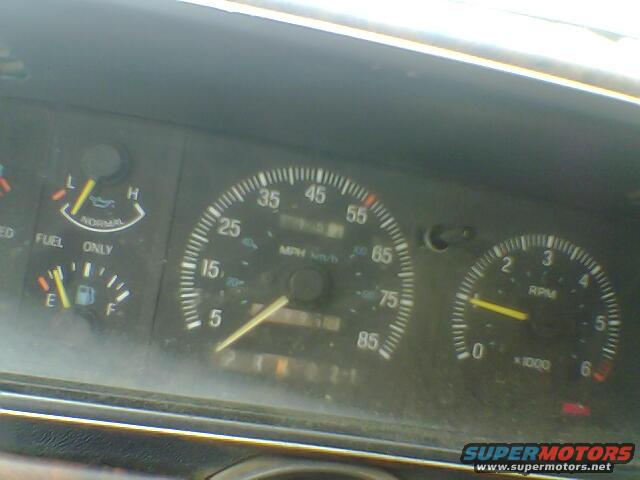 Speedometer, fuel gauge, and tachometer on a vehicle dashboard