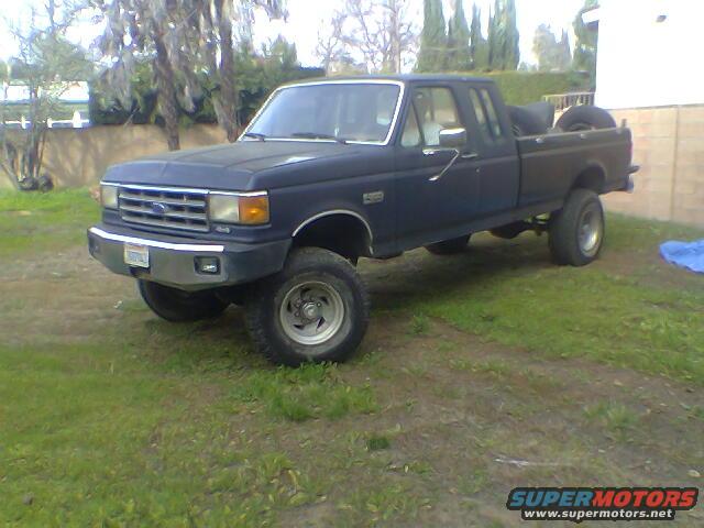 1987 Ford F-250 pickup truck, dark blue, parked on grass