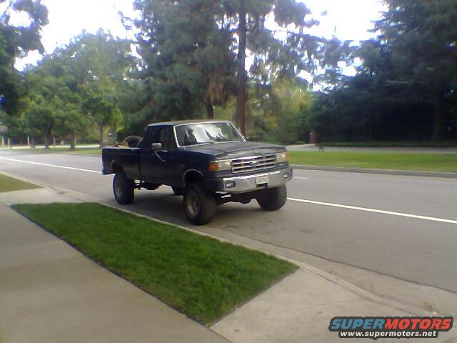 Dark blue 1987 Ford F-250 pickup truck driving on a road