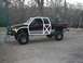 2001 Dodge 1500 - This lifted Dodge Ram pickup truck has a two-tone paint scheme and oversized off-road tires.