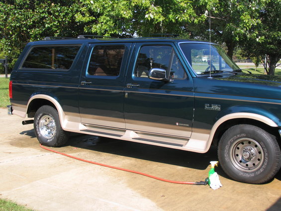 Green Ford SUV with tan trim, side view. Has a 2.5L badge on fender