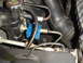 1993 Ford Bronco - This image shows engine bay components including a radiator cap and a blue fuel pressure regulator.