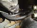 1993 Ford Bronco - Close-up view of engine components, including a black hose and metal parts, with visible rust.