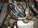 1993 Ford Bronco - Close-up view of the engine compartment, showing various hoses and wiring.