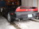1993 Ford Probe - Rear view of a black Acura NSX, showing its distinctive taillights and dual exhaust pipes.