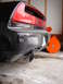 1993 Ford Probe - The rear of a black Acura NSX is shown with a snow blower attachment mounted to the bumper.