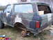 1988 Ford Bronco - This 1988 Ford Bronco is painted in camouflage and is missing a rear wheel, resting on a jack.