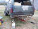 1988 Ford Bronco - A 1988 Ford Bronco, painted in camouflage, is raised on jack stands for maintenance.