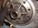 1988 Ford Bronco - A close-up view of a differential gear assembly, with a screwdriver and a gloved hand visible.