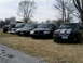 2001 Ford Crown Victoria - Several vehicles are lined up in a grassy area with trees in the background.