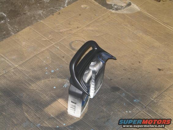 Black motorcycle fairing part on cardboard