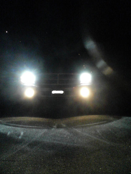 2000 Dodge Durango front view with headlights on at night