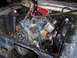 1967 Ford Mustang - Engine hoist suspended over the engine of a 1967 Ford Mustang, showing the blue engine block and chrome air cleaner.