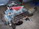 1967 Ford Mustang - A disassembled V8 engine is shown, with its valve covers off and internal components exposed.