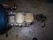 1967 Ford Mustang - Transmission assembly shown on a concrete floor, likely a component from a vehicle.