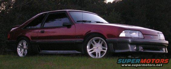 1986 Ford Mustang coupe parked on grass with trees in background