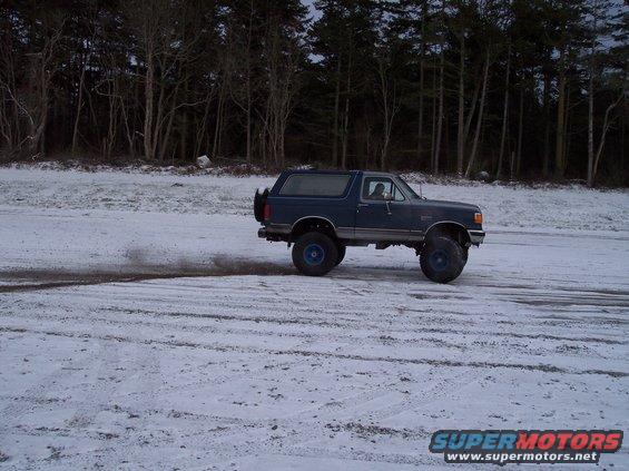 1987 Ford Bronco in 3q-front view on snowy ground