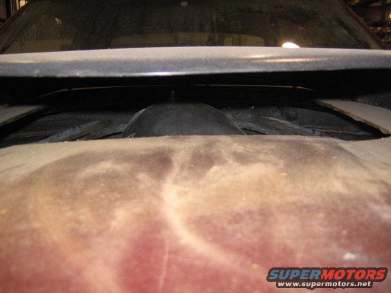Hood scoop opening with dark rubber seal and red body panel