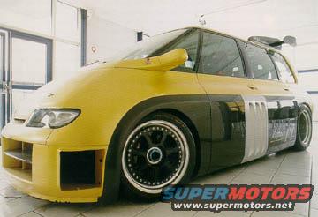 Yellow and black custom van, front bumper removed, large spoiler, custom wheels, side vents
