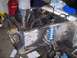 1967 Ford Mustang - The engine bay of a 1967 Ford Mustang shows a disassembled front end with a blue coilover suspension system visible.