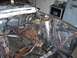 1967 Ford Mustang - The engine bay of a 1967 Ford Mustang shows significant rust and exposed wiring.