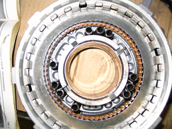 Transmission drum with clutch plates and steel rings, showing wear
