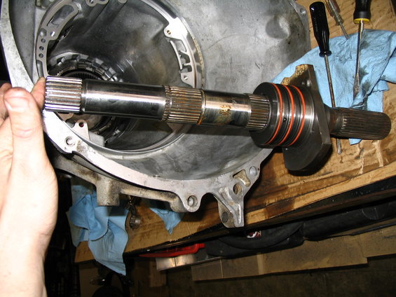 Transmission input shaft with orange seals being removed from housing