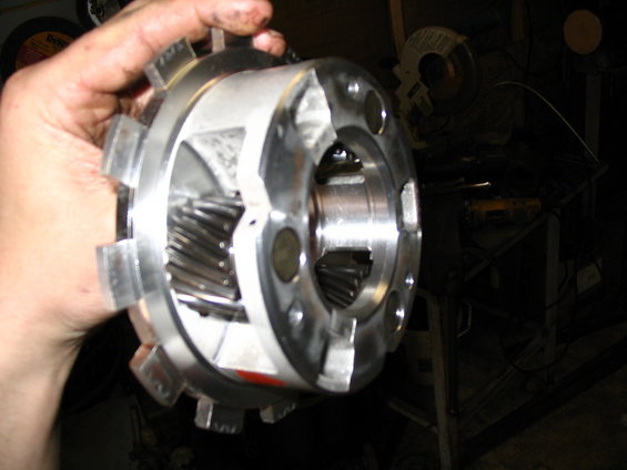 Metal transmission component with visible gears held by a hand