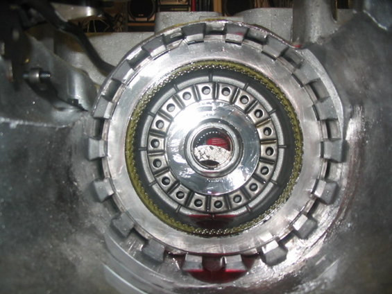 Close-up of an automatic transmission torque converter with red fluid visible