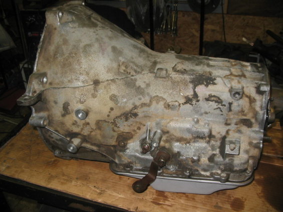 Old automatic transmission sitting on a wooden surface